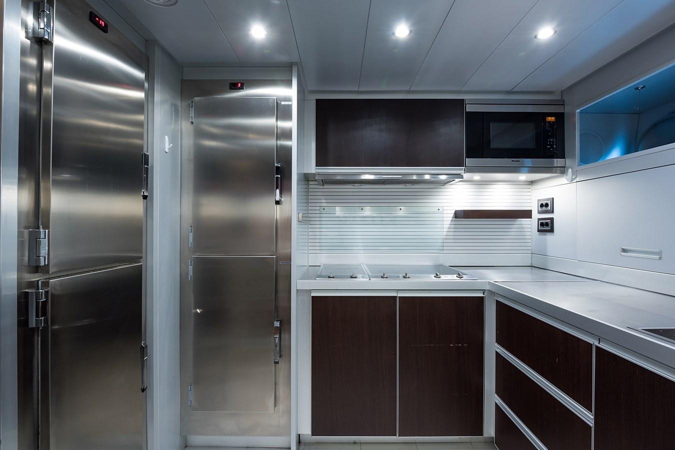 a kitchen with stainless steel appliances aboard 34M LEOPARD Yacht for Sale