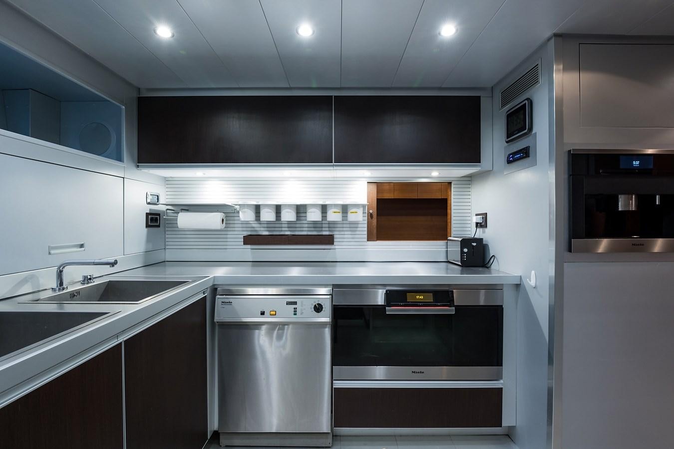 a kitchen with a stove and sink aboard 34M LEOPARD Yacht for Sale
