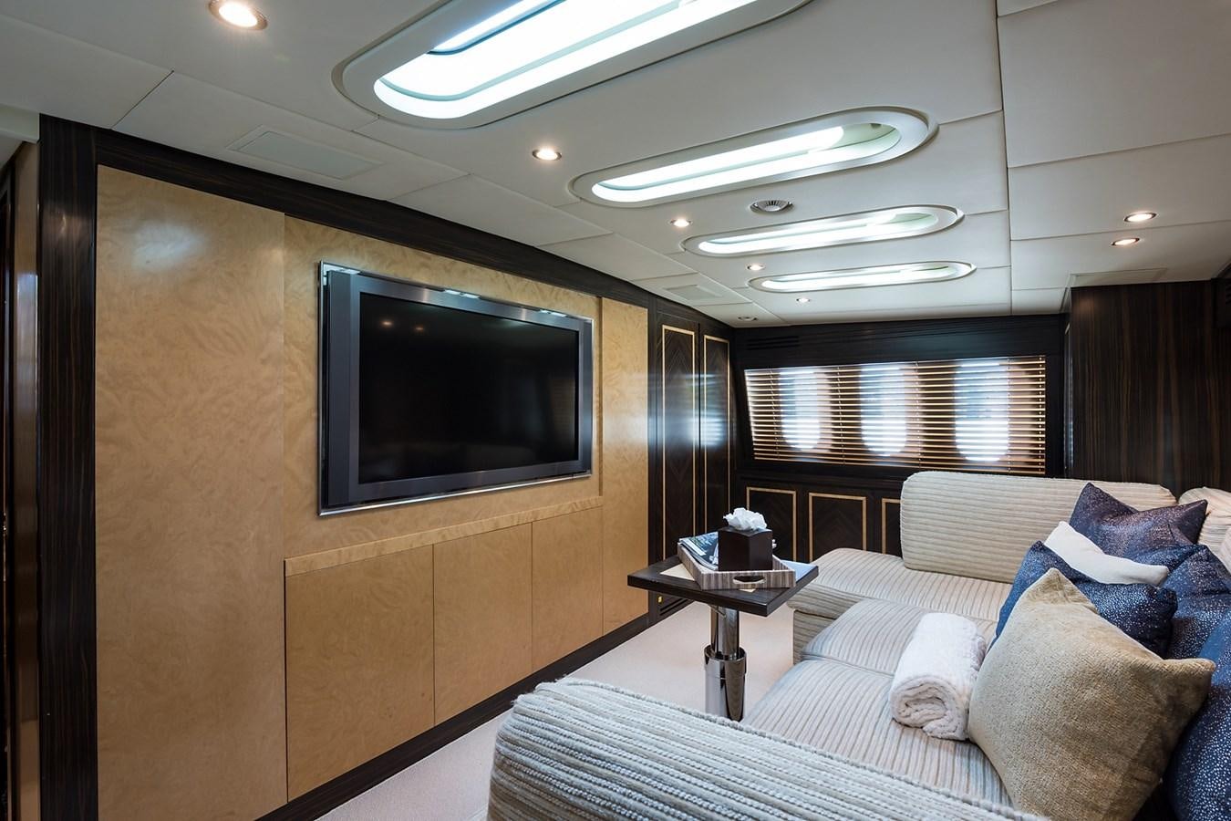 a living room with a tv and couches aboard 34M LEOPARD Yacht for Sale