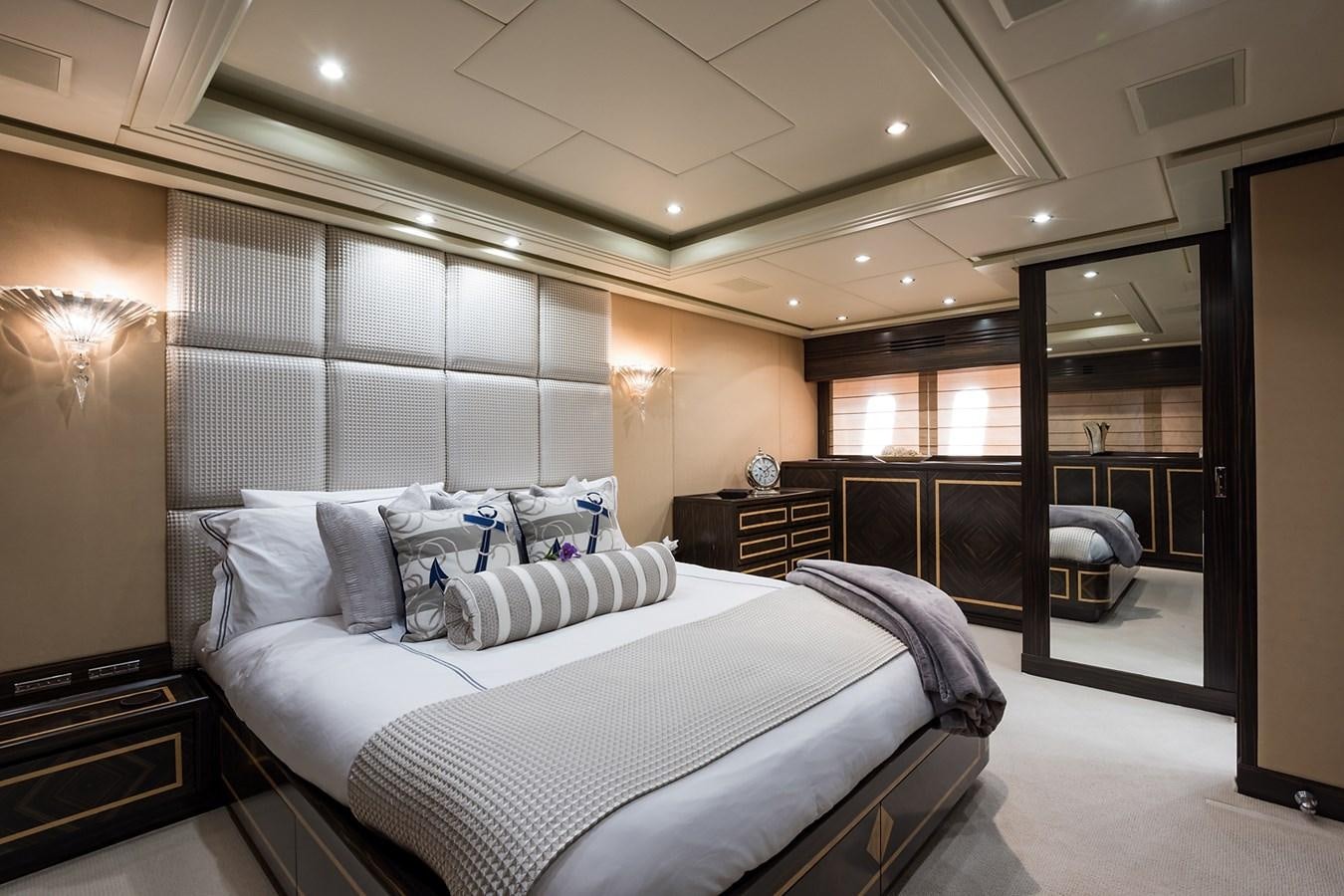 a bedroom with a large bed aboard 34M LEOPARD Yacht for Sale