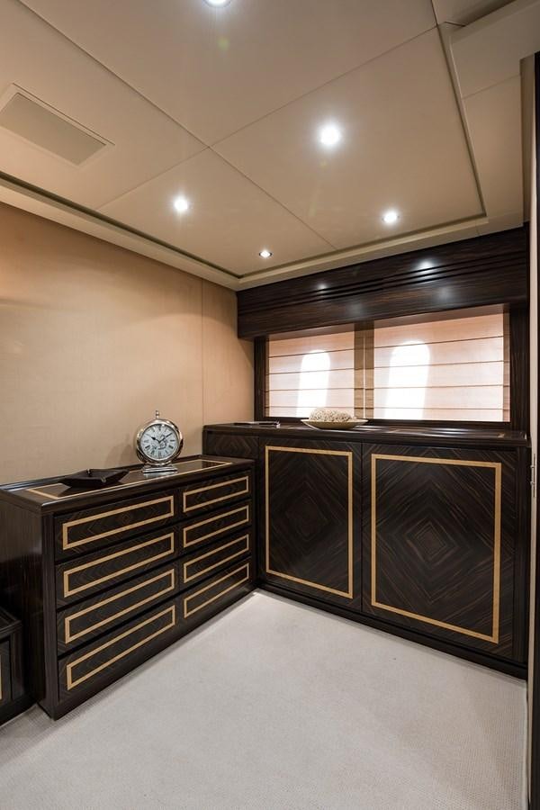 a room with a clock and cabinets aboard 34M LEOPARD Yacht for Sale