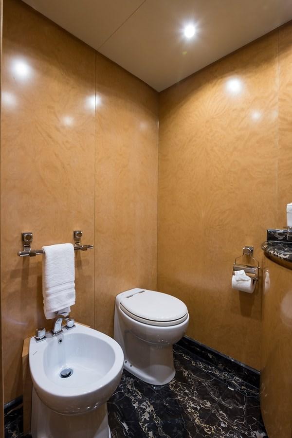 a bathroom with a toilet and sink aboard 34M LEOPARD Yacht for Sale