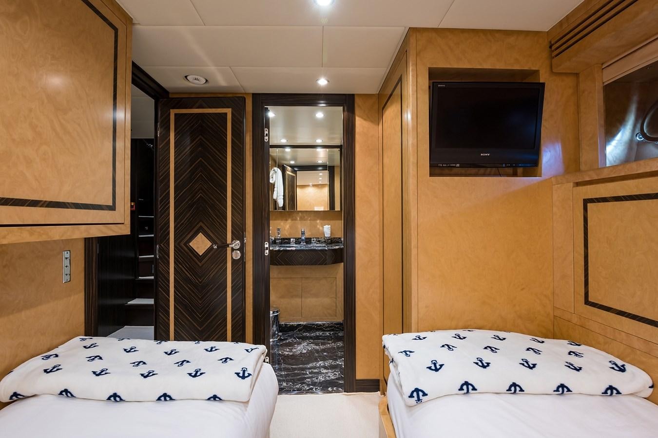 a room with a bed and a tv aboard 34M LEOPARD Yacht for Sale