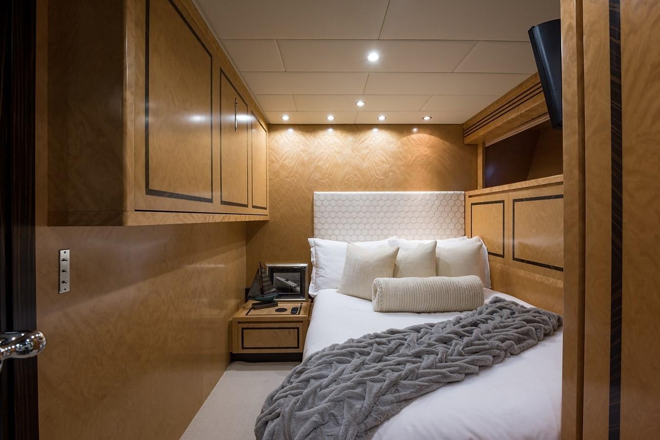 a room with a bed and a desk aboard 34M LEOPARD Yacht for Sale