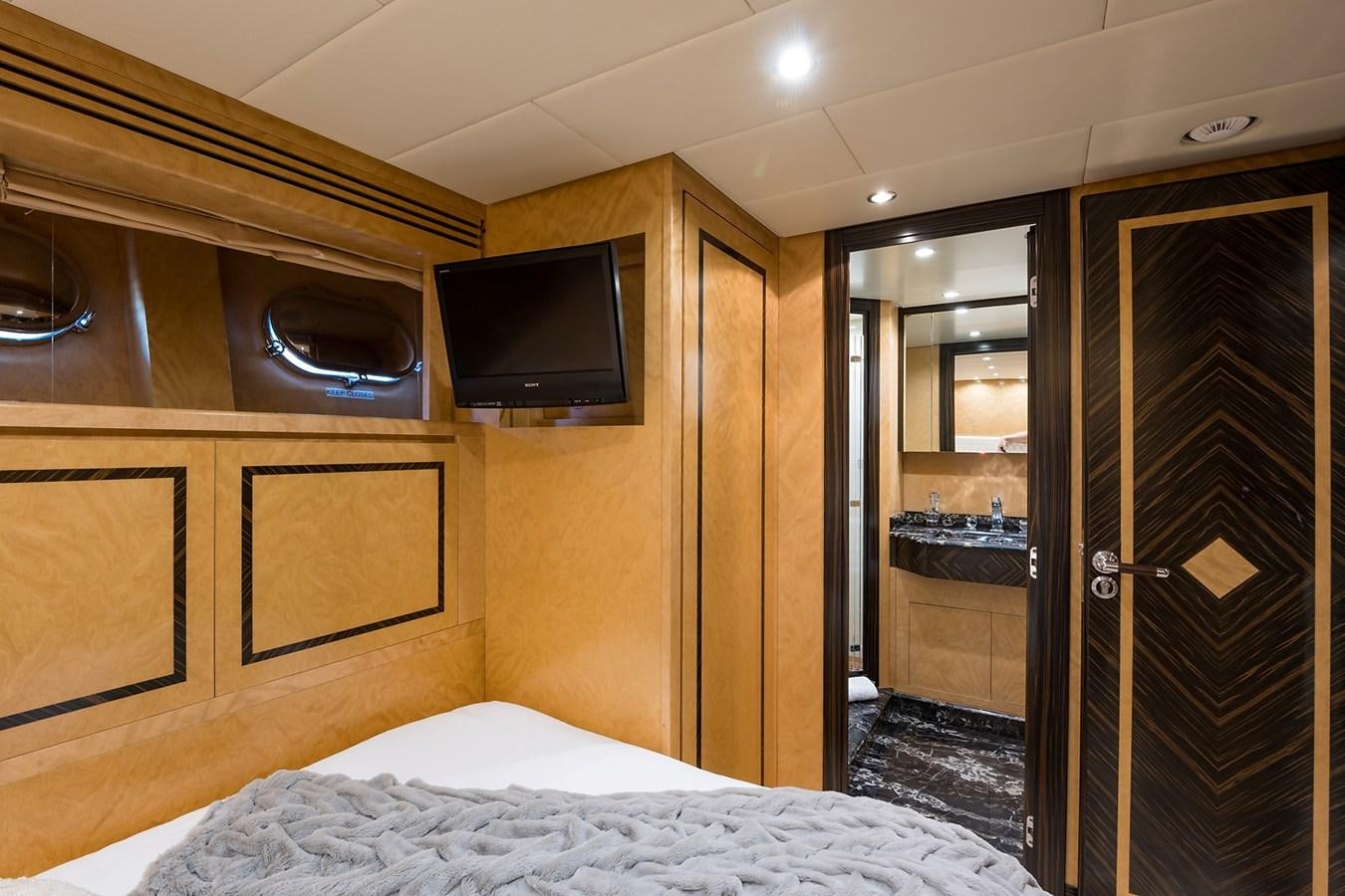 a bedroom with a bed and a television aboard 34M LEOPARD Yacht for Sale