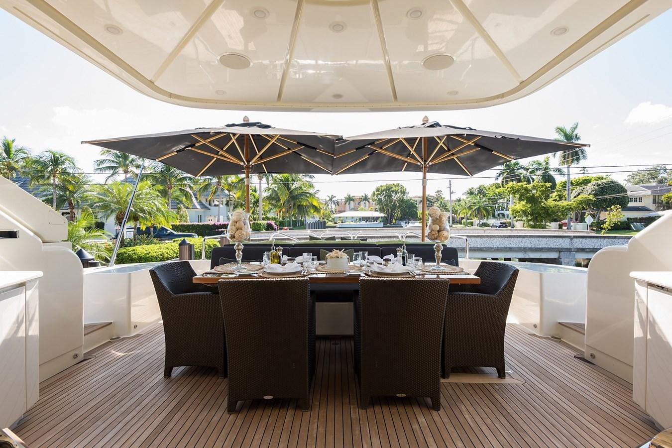 a large room with a table and chairs and umbrellas aboard 34M LEOPARD Yacht for Sale