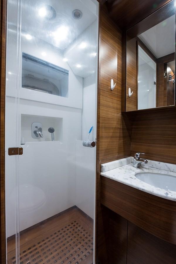 a bathroom with a sink and a mirror aboard 34M LEOPARD Yacht for Sale