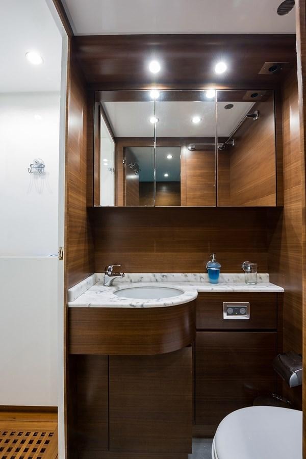 a bathroom with a sink and a mirror aboard 34M LEOPARD Yacht for Sale