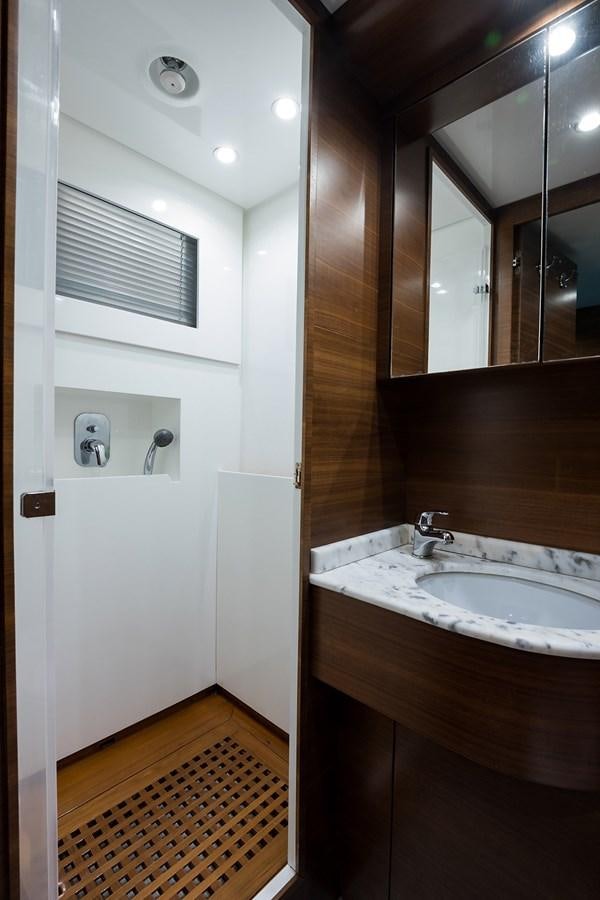 a bathroom with a sink and a mirror aboard 34M LEOPARD Yacht for Sale