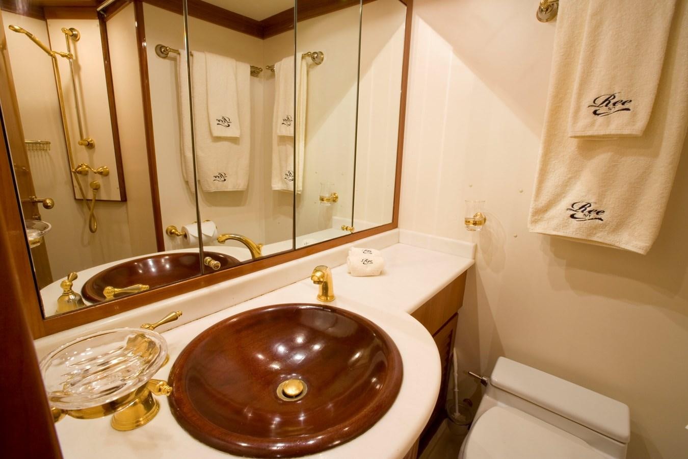 a bathroom with a sink and a mirror aboard REE Yacht for Charter