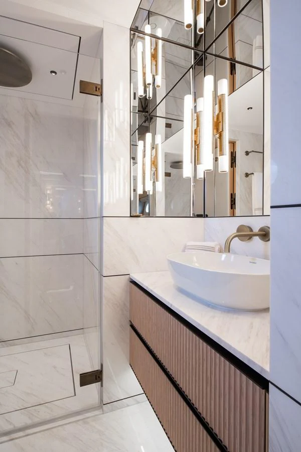 a bathroom with a sink and a mirror aboard MOONEN 110 MUSTIQUE Yacht for Sale
