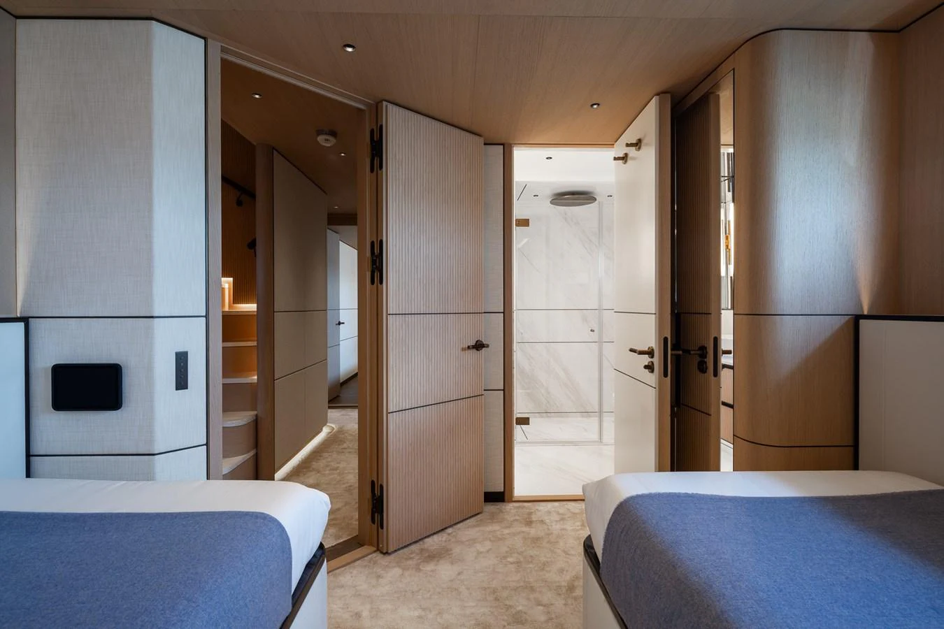 a room with a bed and a blue bed aboard MOONEN 110 MUSTIQUE Yacht for Sale