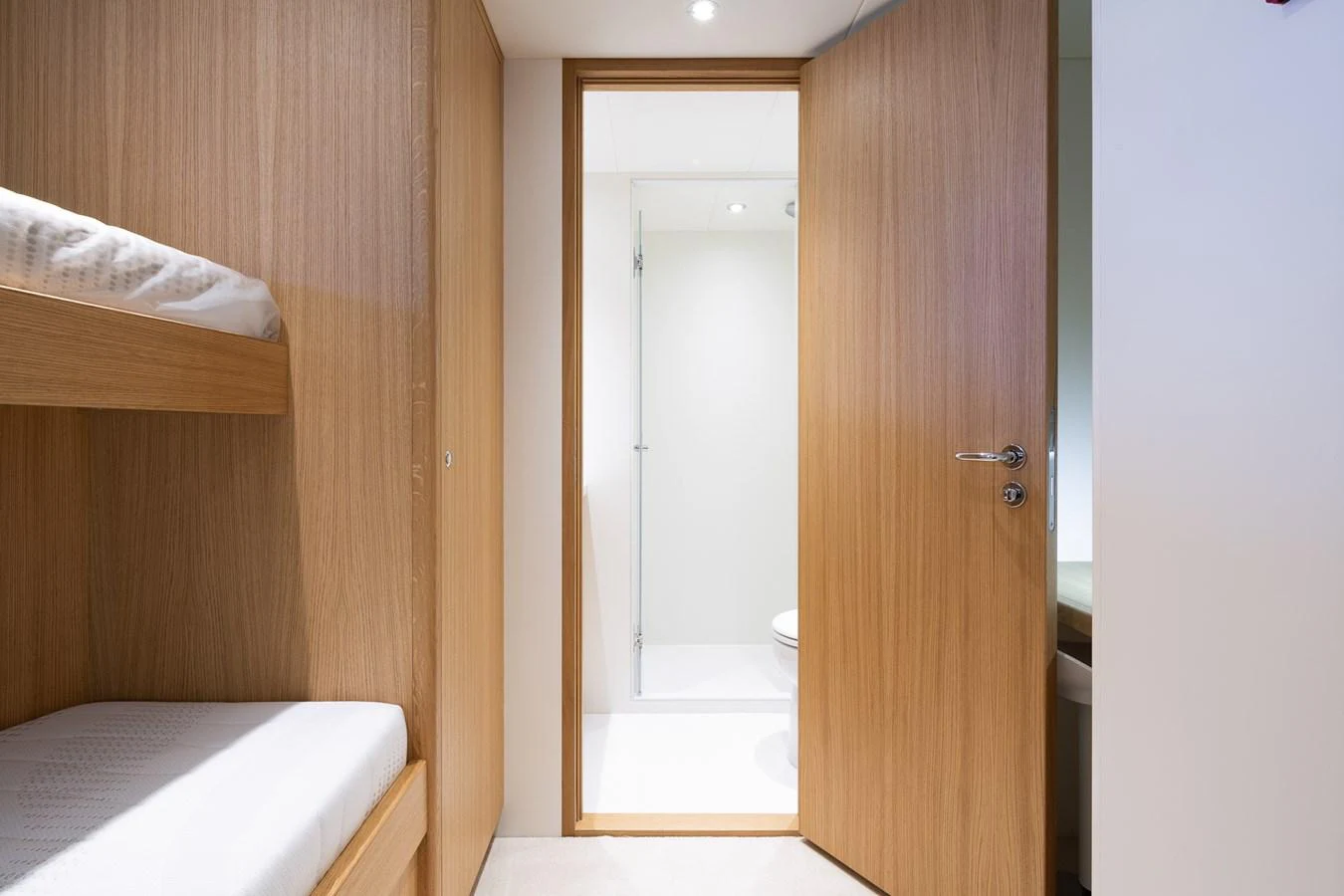 a room with a bed and a closet aboard MOONEN 110 MUSTIQUE Yacht for Sale