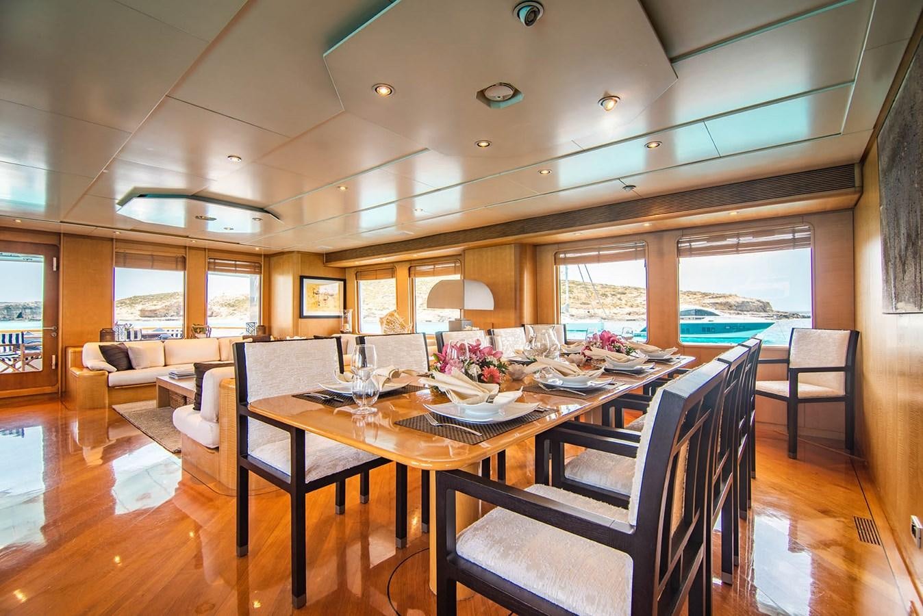 a dining room with a table and chairs aboard CRISS C Yacht for Sale
