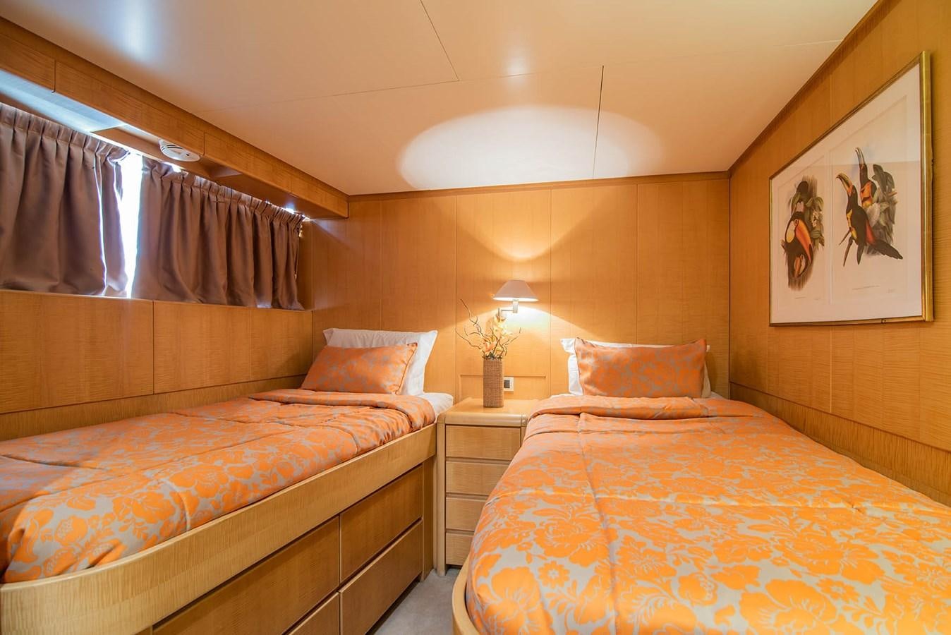 a bedroom with two beds aboard CRISS C Yacht for Sale