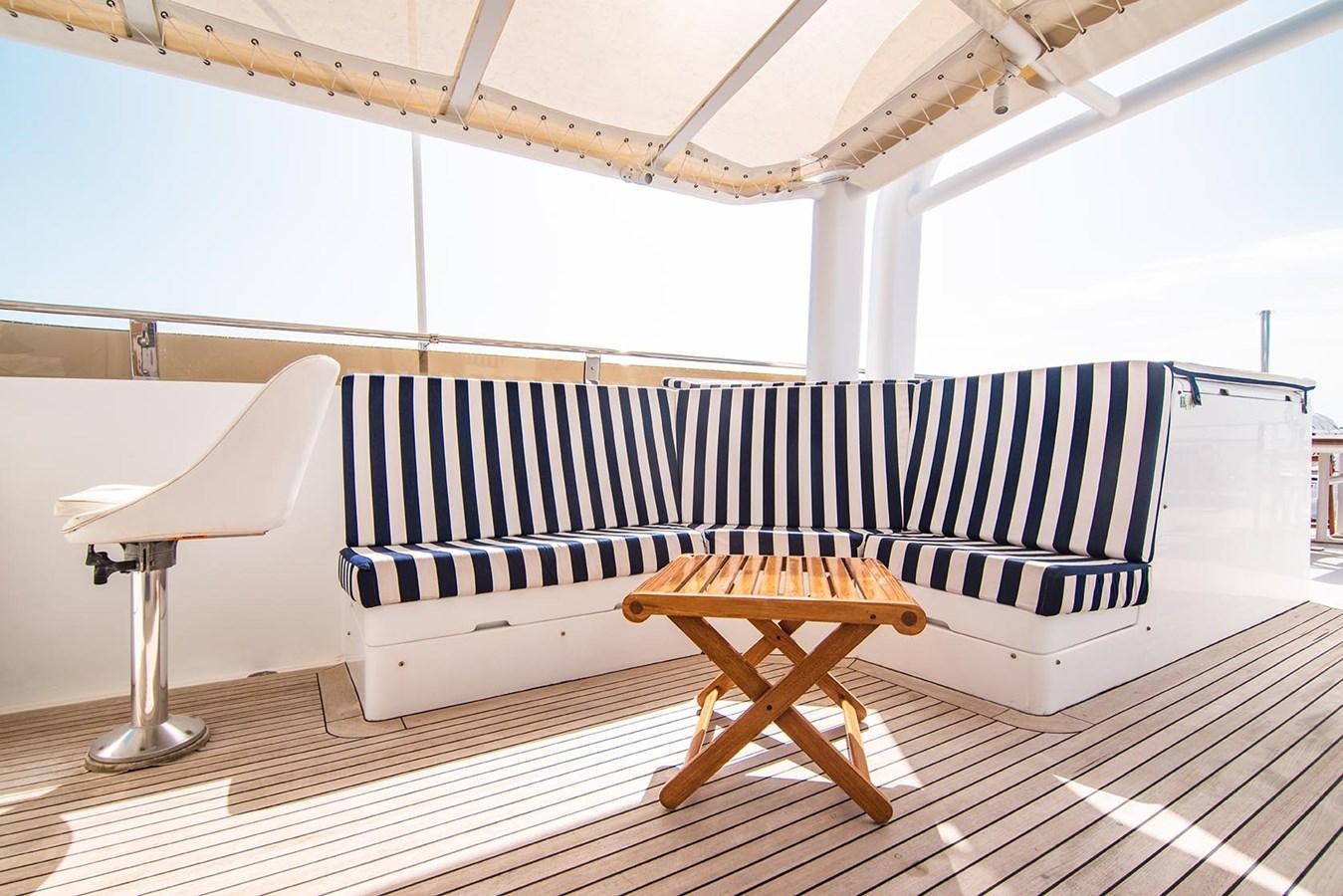 a couch and a chair in a room aboard CRISS C Yacht for Sale