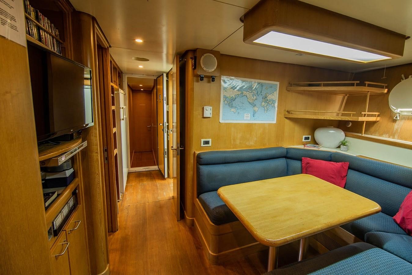 a living room with a couch and a television aboard CRISS C Yacht for Sale