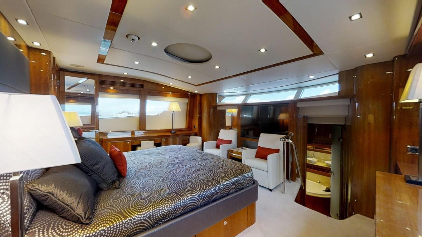 a bedroom with a bed and a desk aboard WHITE PEARL I Yacht for Sale