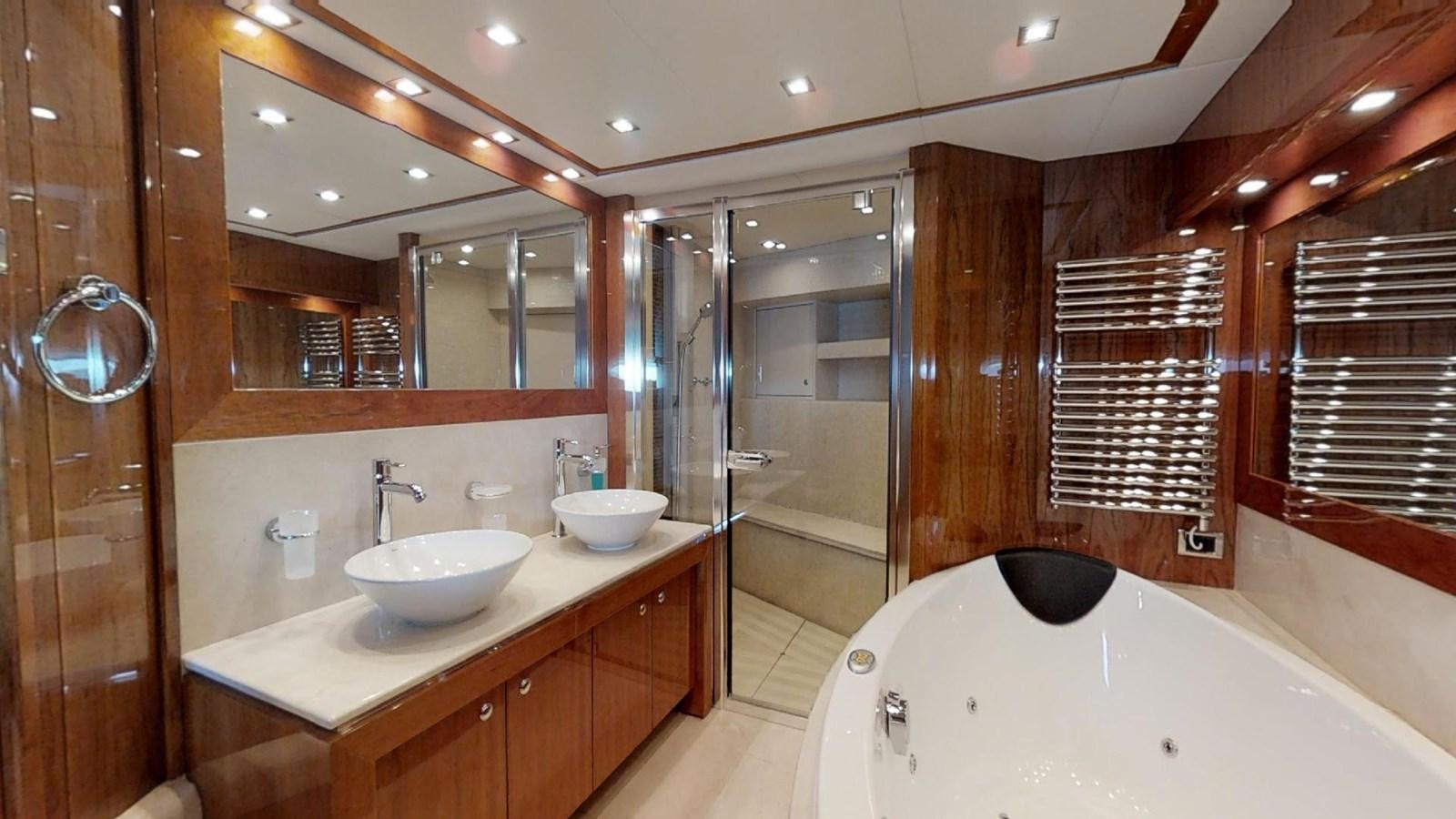 a bathroom with a tub sink and a mirror aboard WHITE PEARL I Yacht for Sale