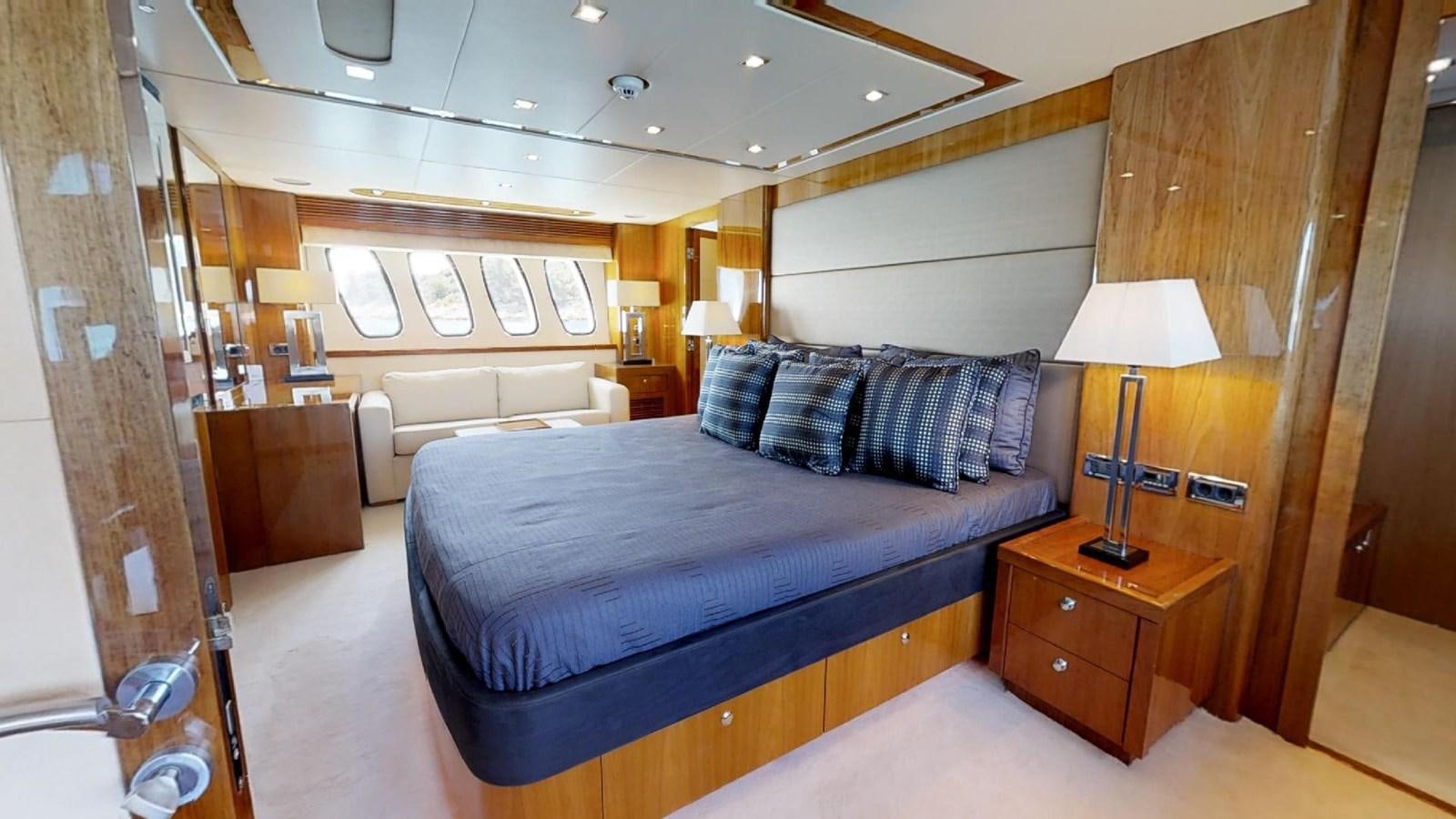 a bedroom with a bed and a desk aboard WHITE PEARL I Yacht for Sale