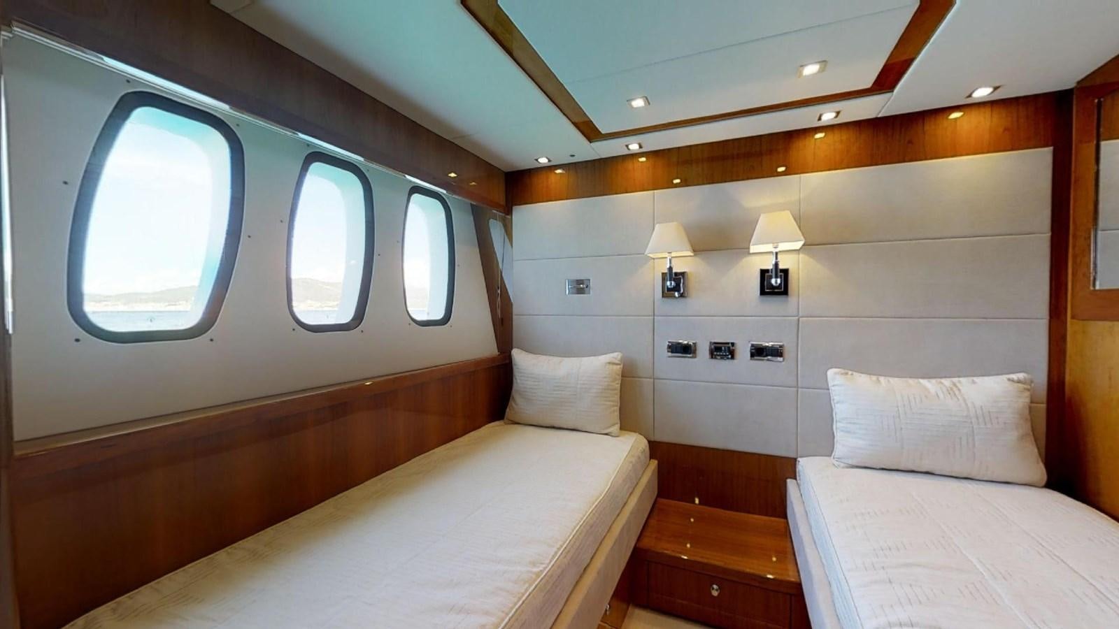 a room with a bed and a window aboard WHITE PEARL I Yacht for Sale