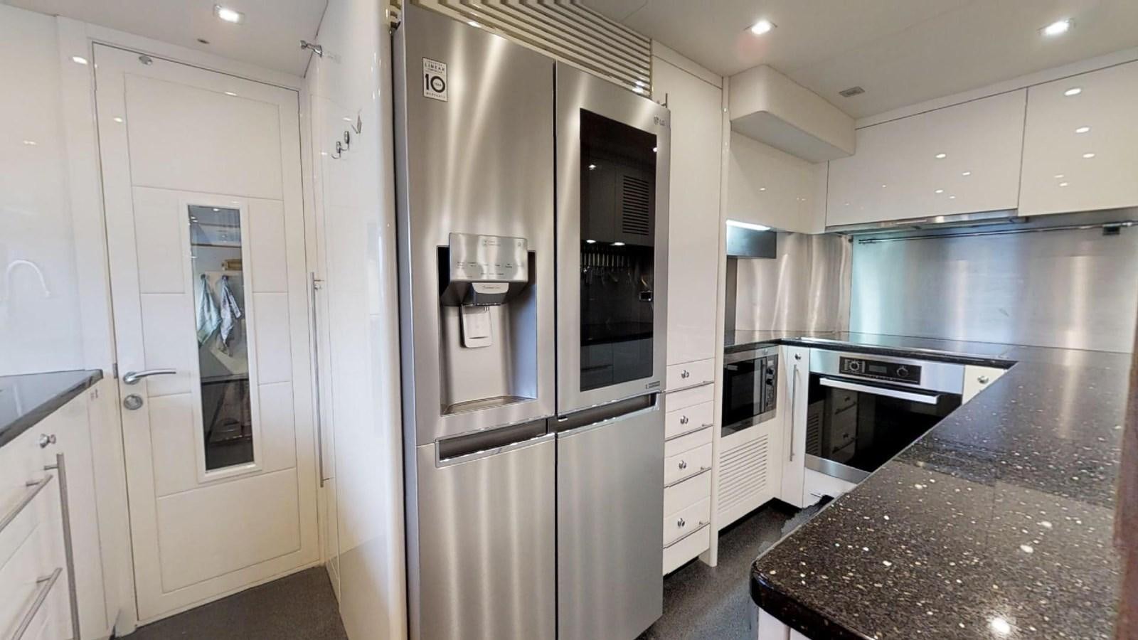 a kitchen with white cabinets aboard WHITE PEARL I Yacht for Sale