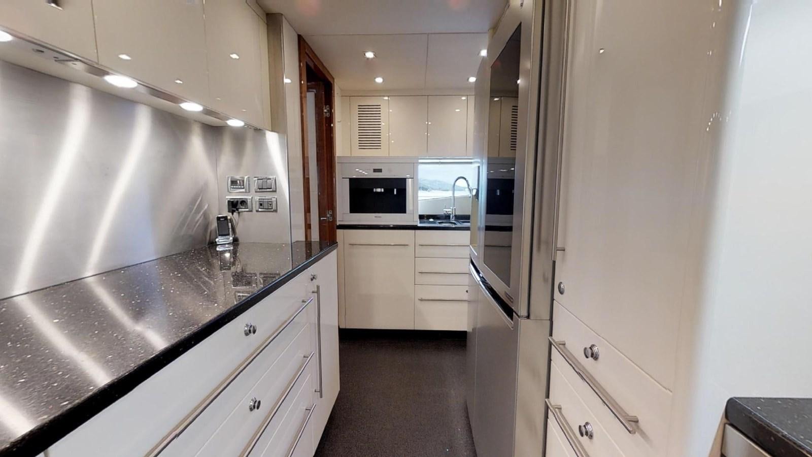 a kitchen with white cabinets aboard WHITE PEARL I Yacht for Sale