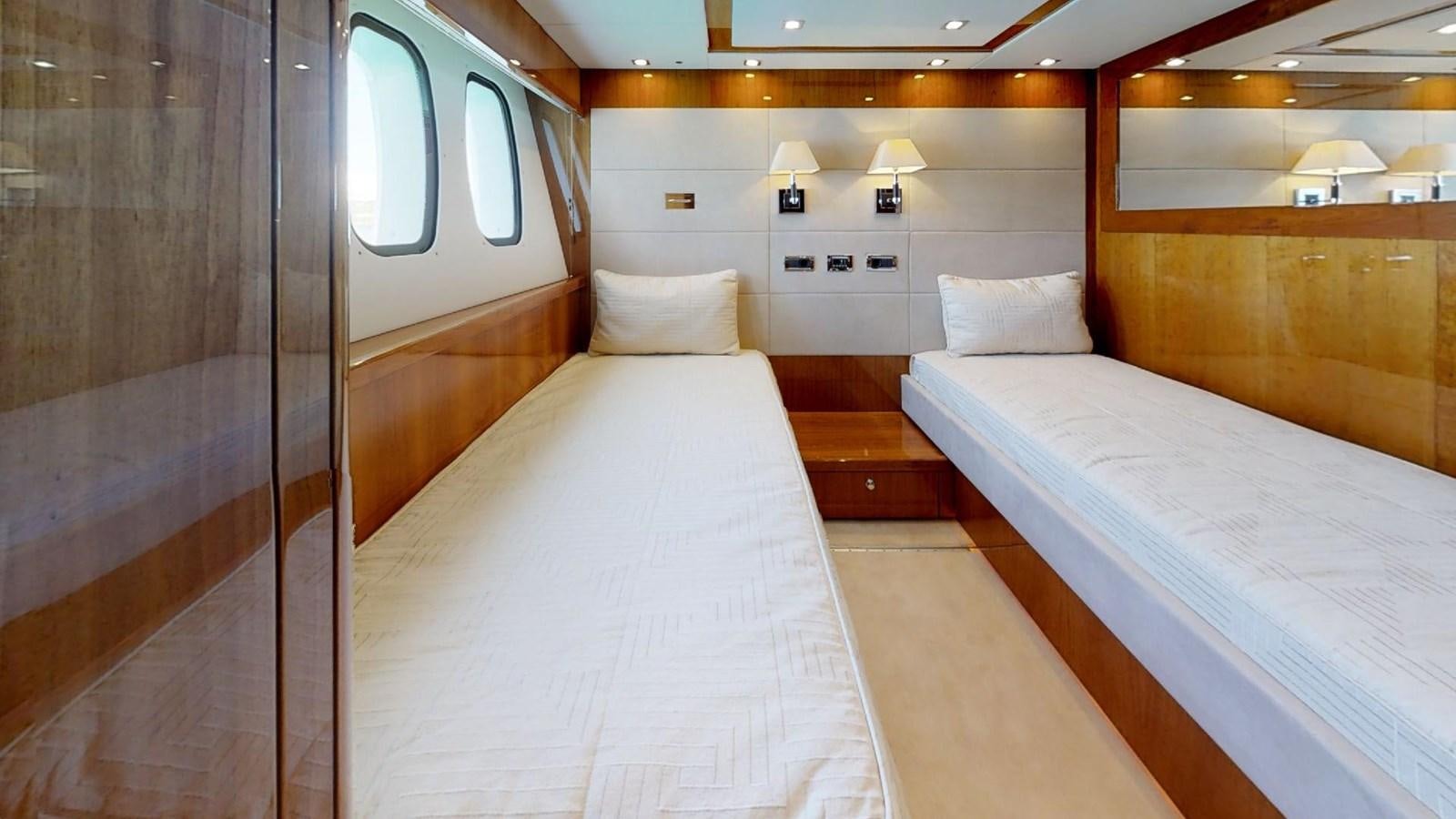 a room with beds and a mirror aboard WHITE PEARL I Yacht for Sale