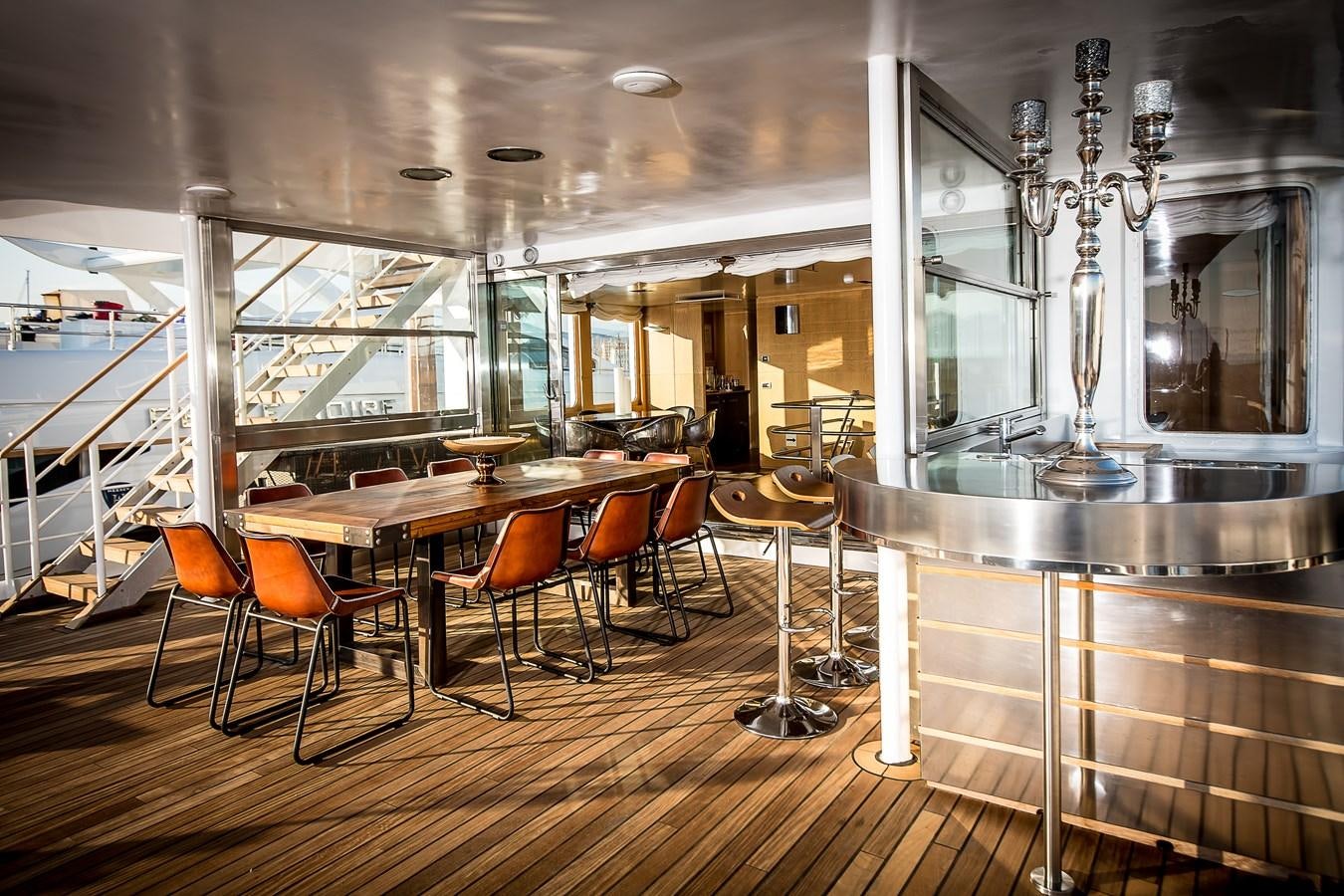 a room with tables and chairs aboard ALTER EGO Yacht for Sale