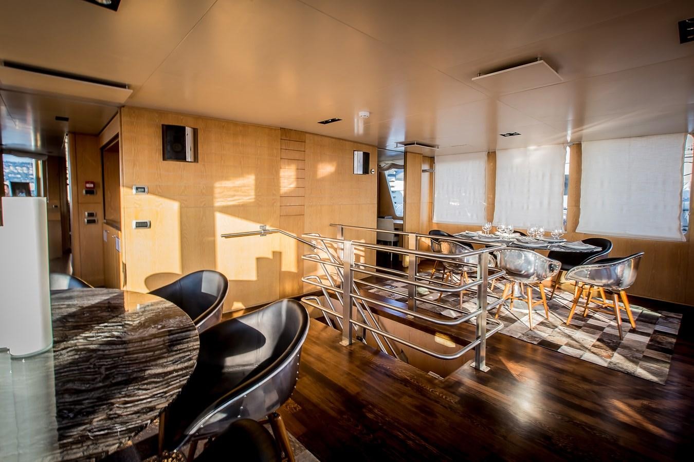 a room with tables and chairs aboard ALTER EGO Yacht for Sale