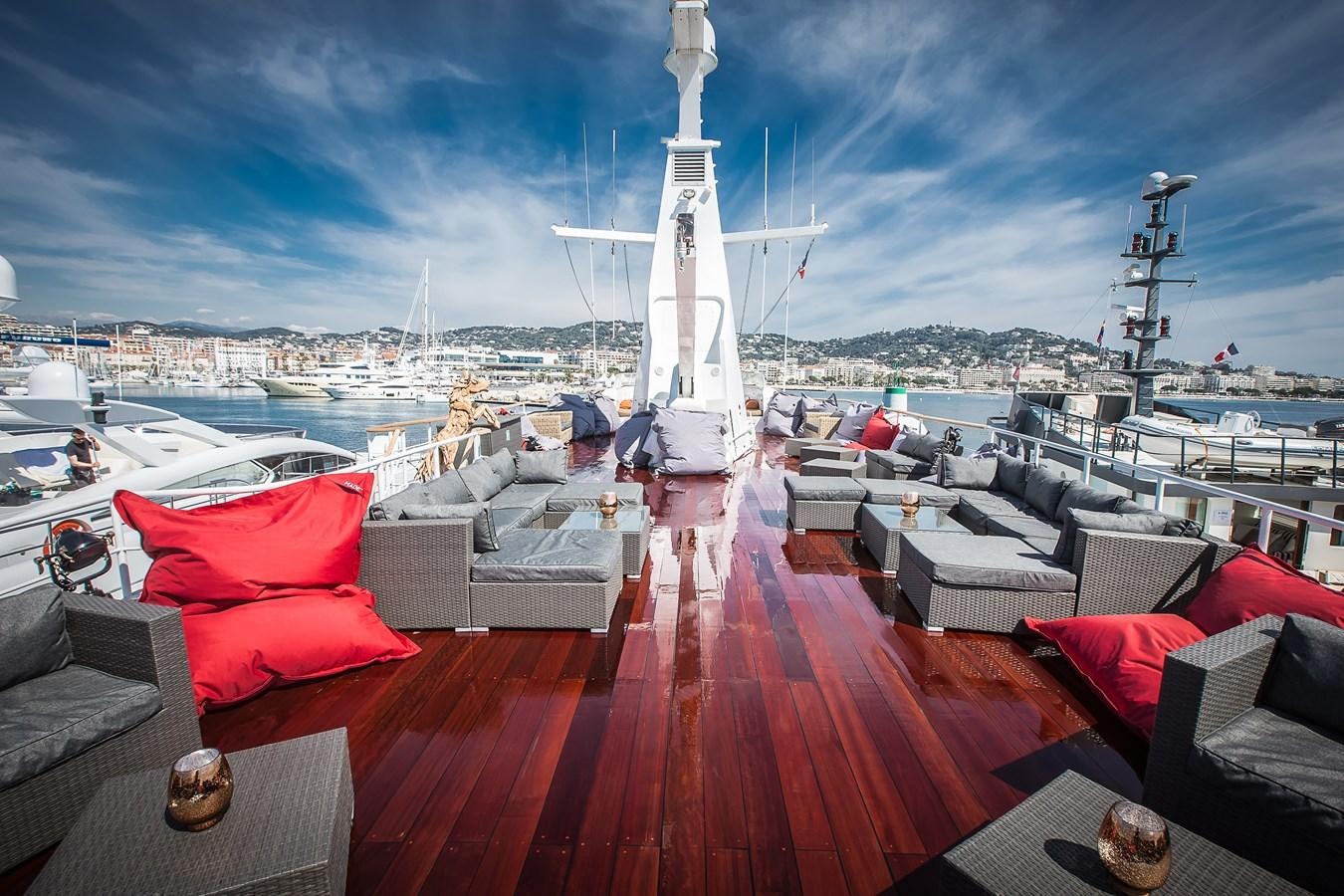 a deck with a large ship in the background aboard ALTER EGO Yacht for Sale