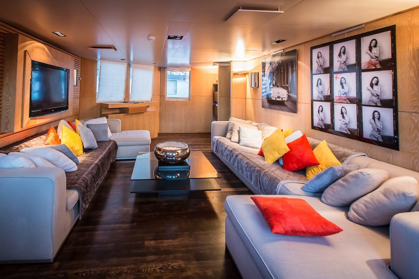 a living room with a couch and a tv aboard ALTER EGO Yacht for Sale