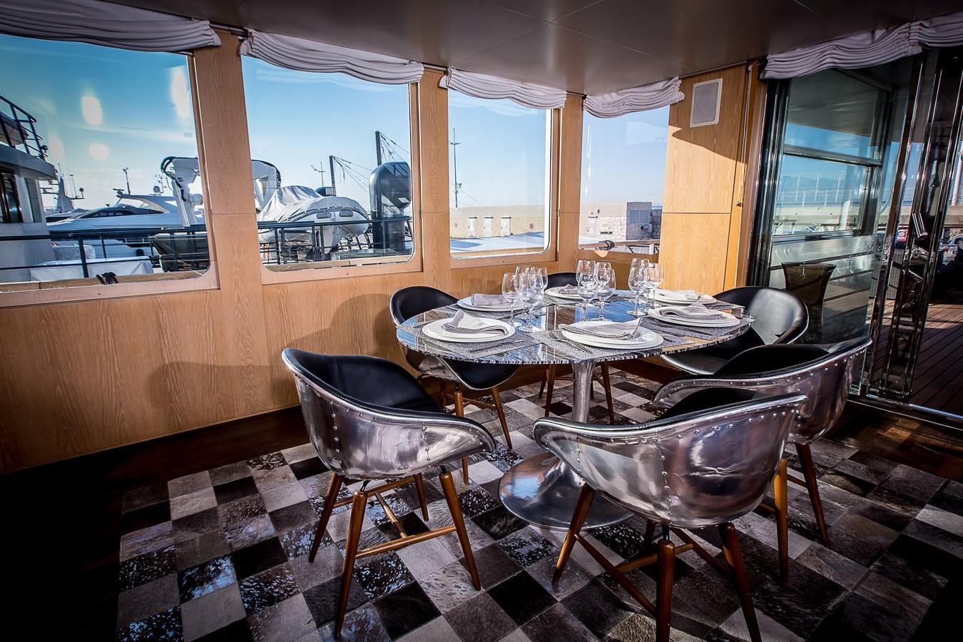 a dining room with a table and chairs aboard ALTER EGO Yacht for Sale