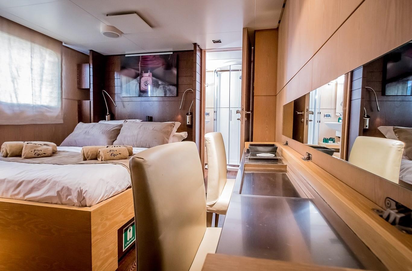 a room with a bed and a mirror aboard ALTER EGO Yacht for Sale