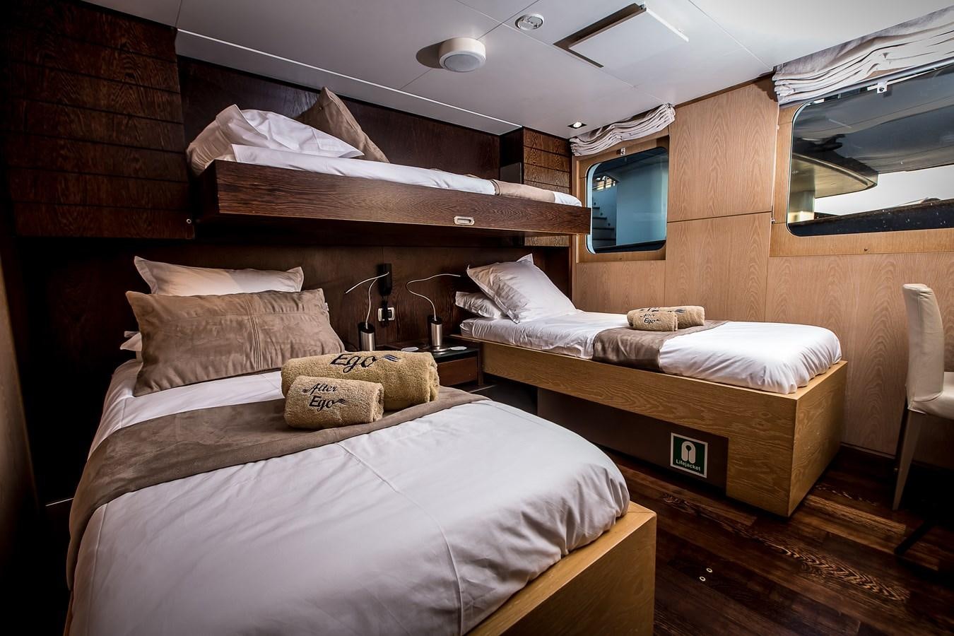 a room with a bed and a television aboard ALTER EGO Yacht for Sale