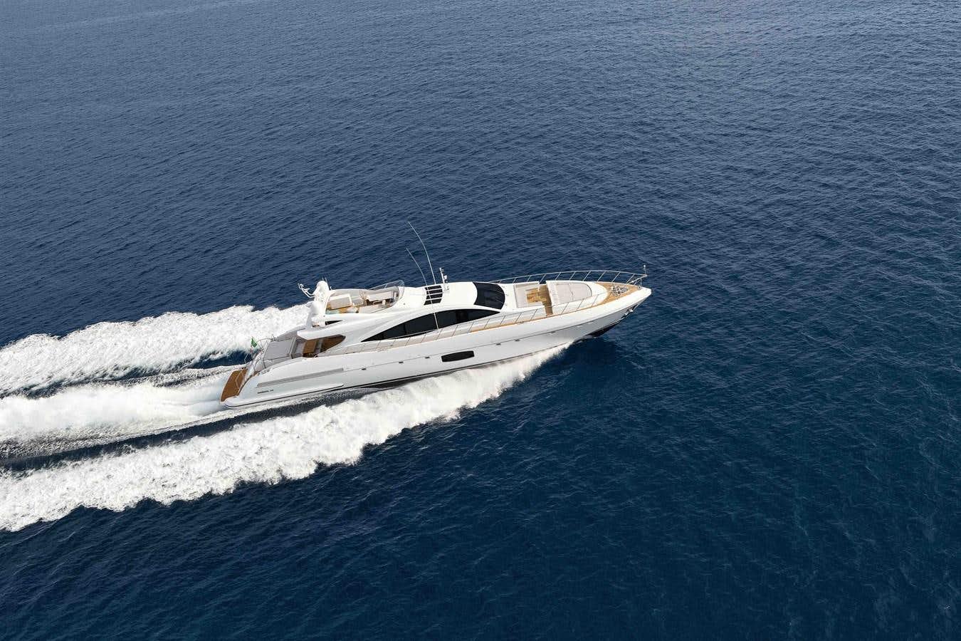 a white boat in the water aboard MANGUSTA 110 - CAREFULLY USED Yacht for Sale