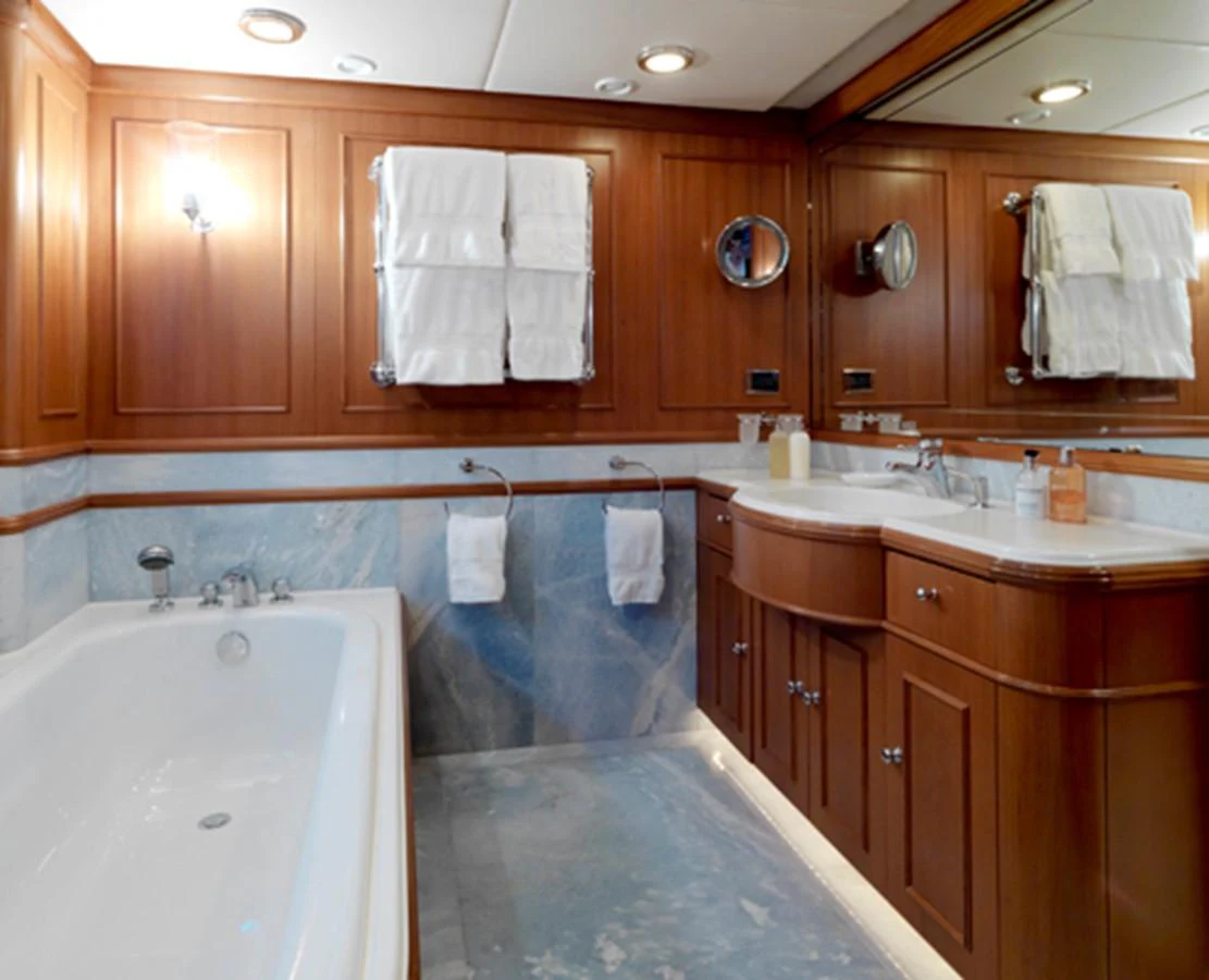 a bathroom with a tub sink and cabinets aboard SPADA Yacht for Sale