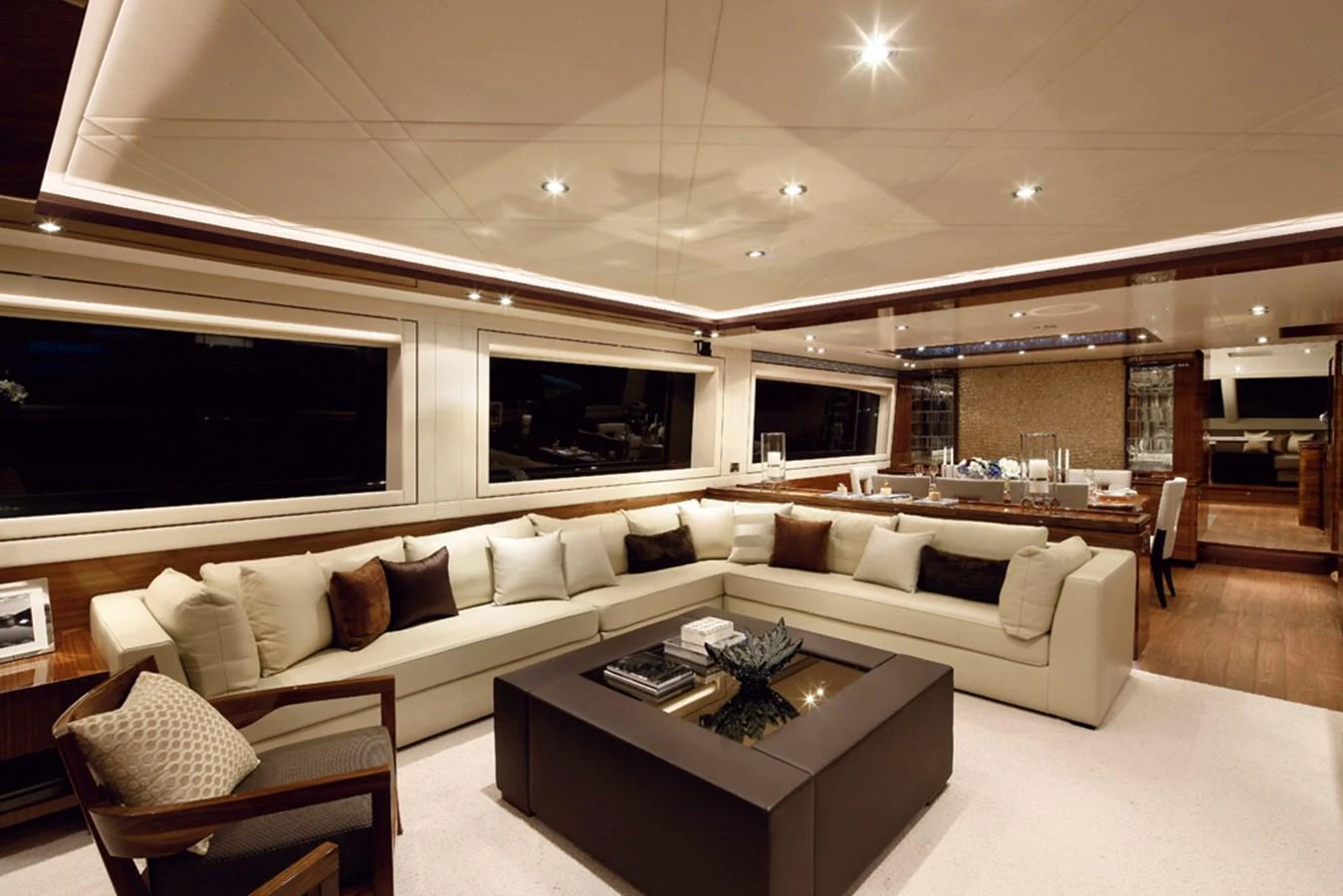 a living room with a large white sofa and a large window aboard P110 (NEW BOAT SPEC) Yacht for Sale