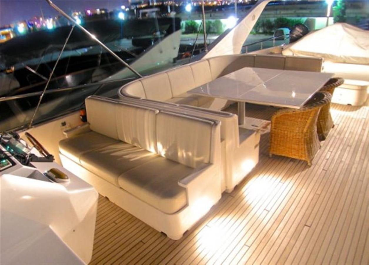 a room with a large white table and chairs aboard TECNOMAR 34 NADARA Yacht for Sale