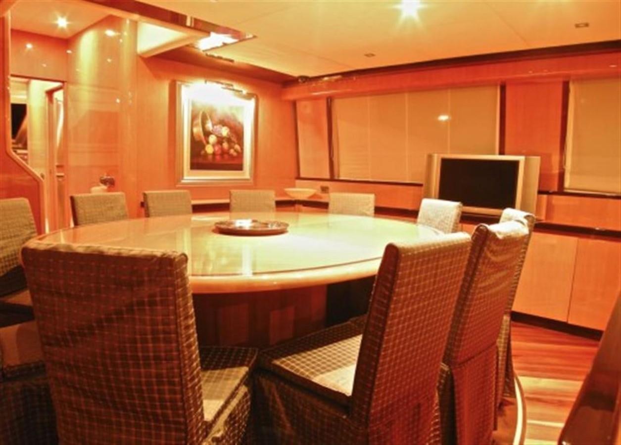 a room with tables and chairs aboard TECNOMAR 34 NADARA Yacht for Sale