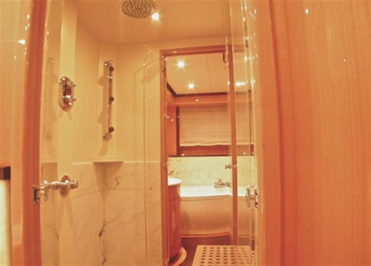 a bathroom with a glass shower door aboard TECNOMAR 34 NADARA Yacht for Sale