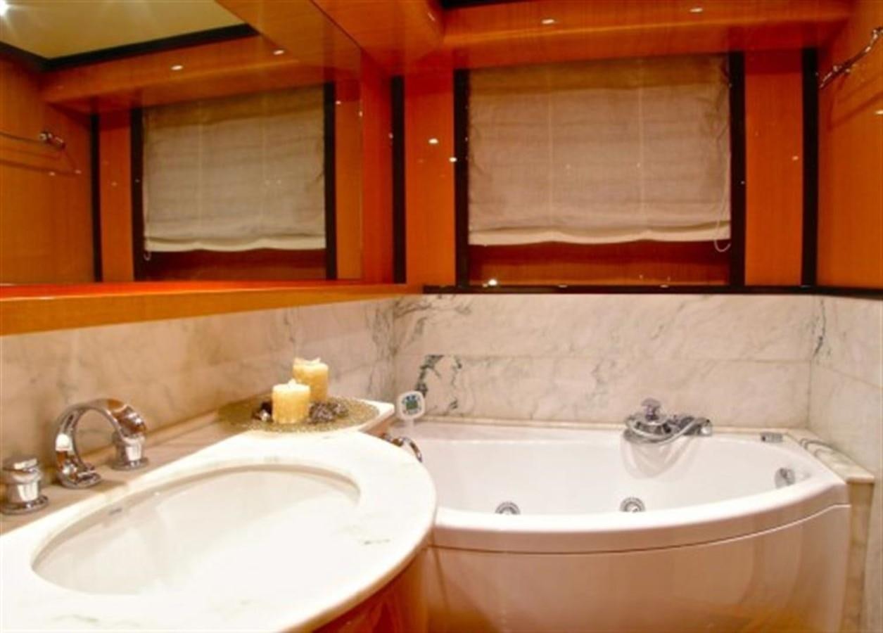 a bathroom with a tub sink and a mirror aboard TECNOMAR 34 NADARA Yacht for Sale