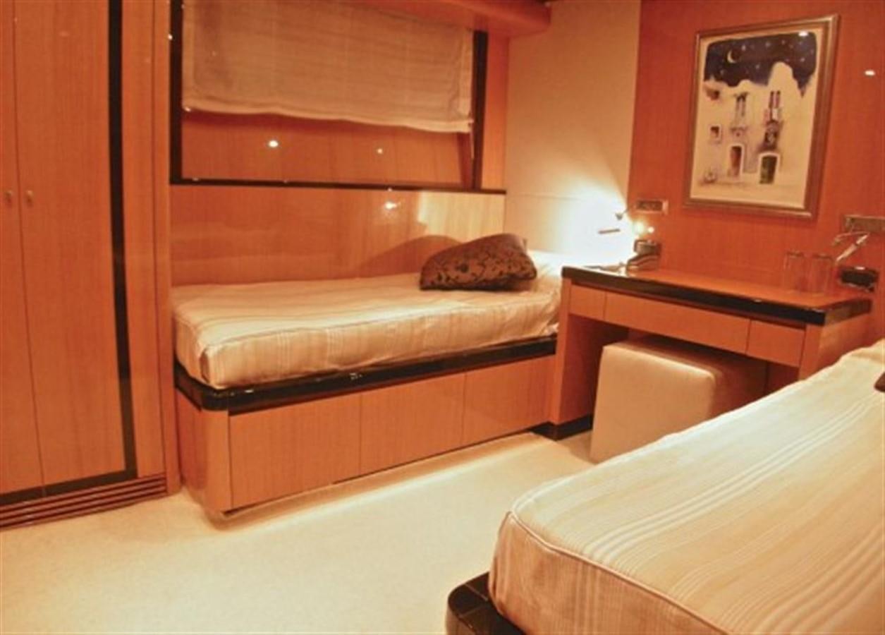 a room with a bed and a desk aboard TECNOMAR 34 NADARA Yacht for Sale