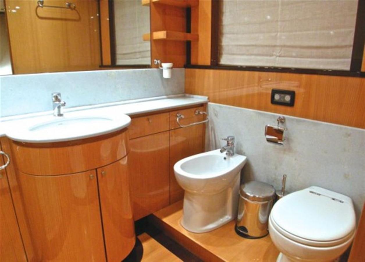 a bathroom with a toilet sink and a mirror aboard TECNOMAR 34 NADARA Yacht for Sale