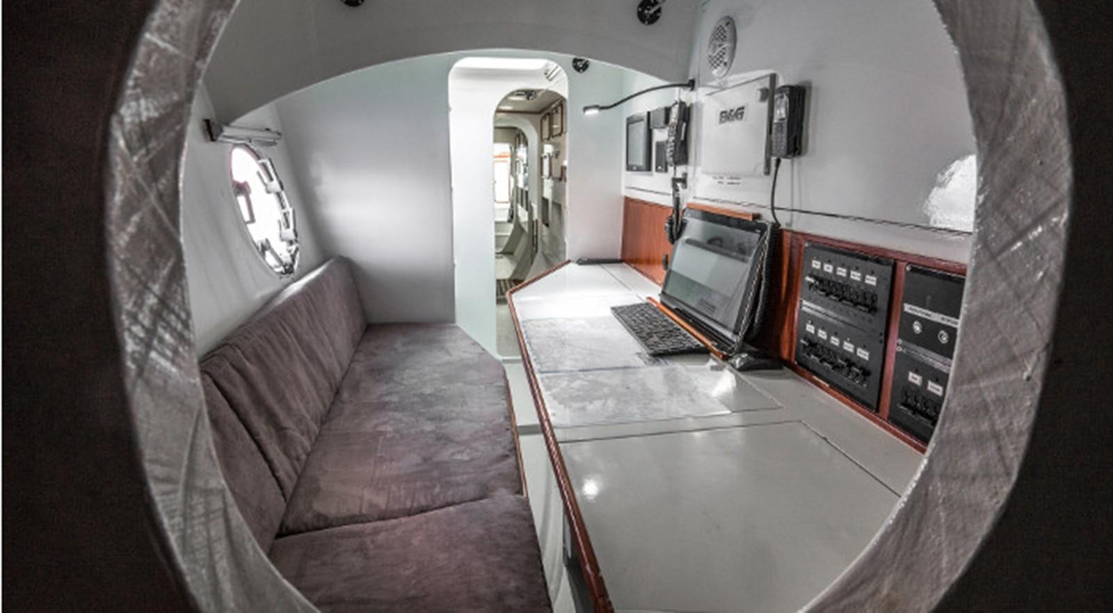 a room with a couch and a laptop on a table aboard OCEAN PEARL Yacht for Sale