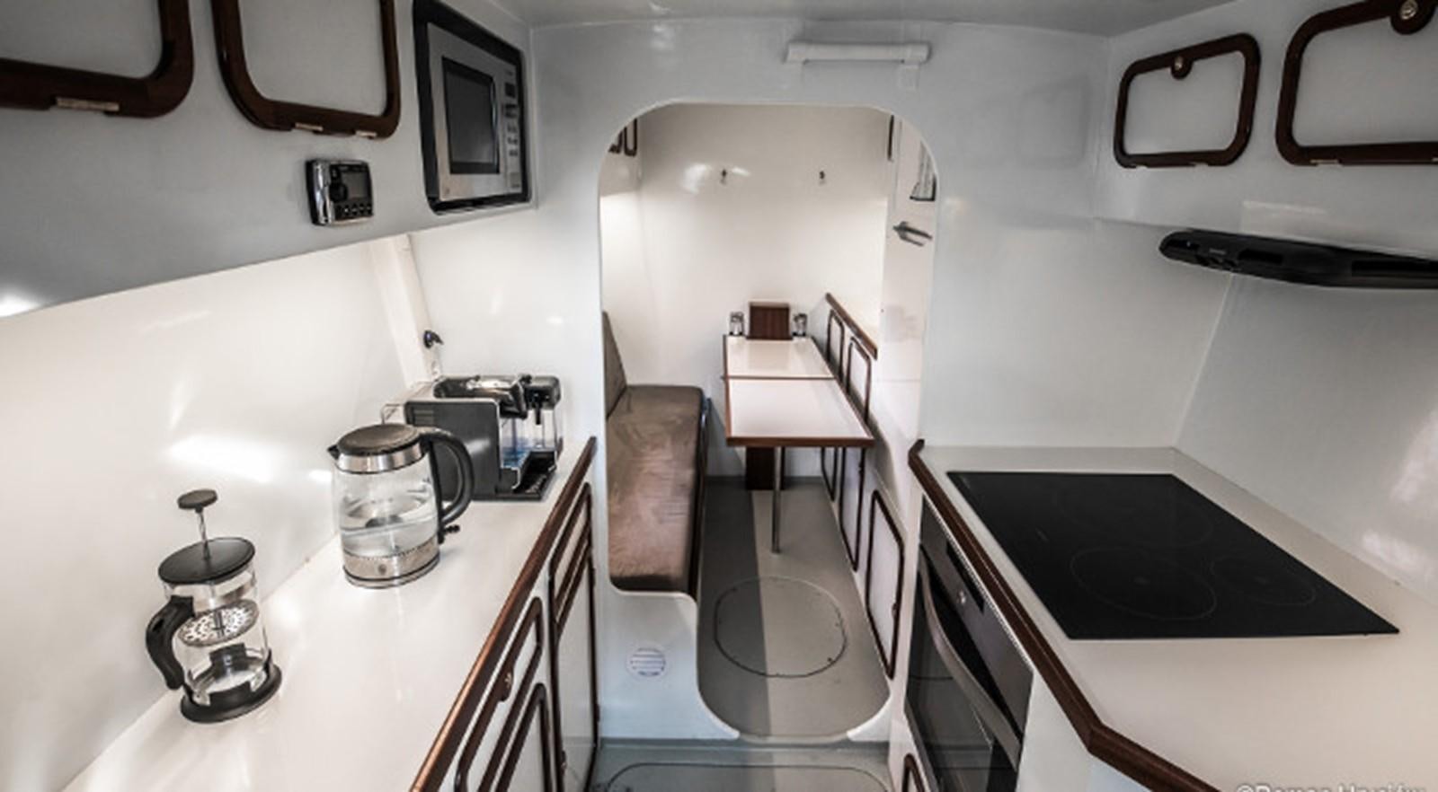 a white room with a table and chairs aboard OCEAN PEARL Yacht for Sale