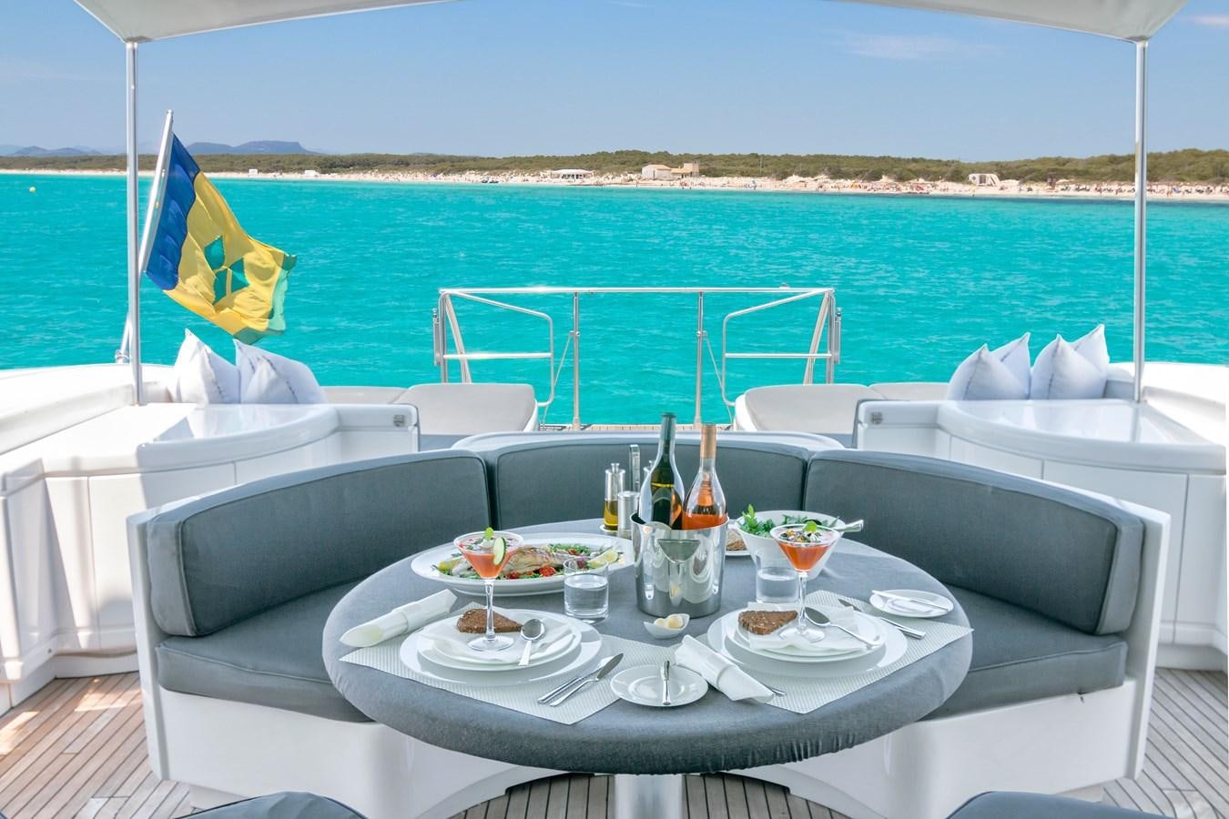a table with plates and glasses on it on a boat aboard LE MAGNIFIQUE Yacht for Sale