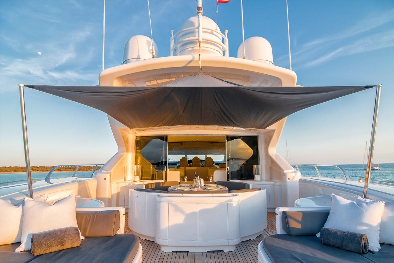 a large outdoor bar with a large white lounge chair and a large white lounge chair and a large aboard LE MAGNIFIQUE Yacht for Sale