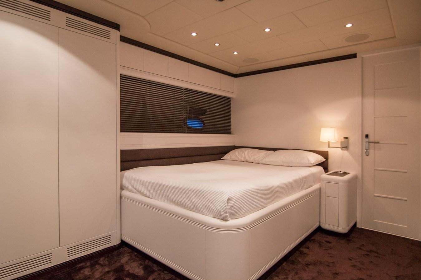 a room with a bed and a lamp aboard LE MAGNIFIQUE Yacht for Sale