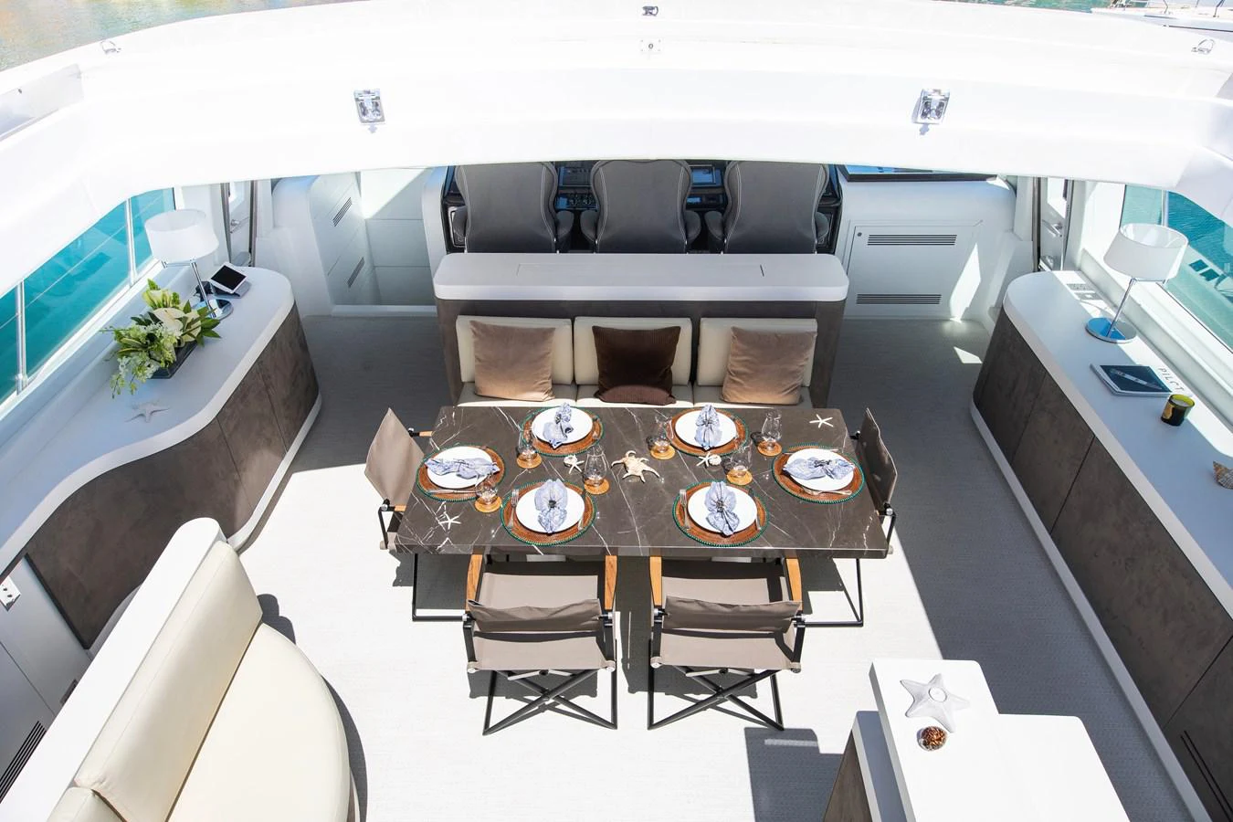 a dining table with chairs aboard YALLA Yacht for Sale